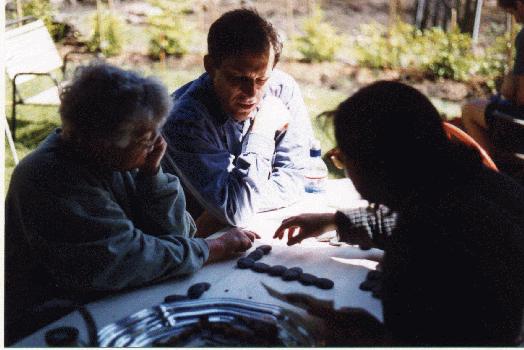 Ricki, Peter, and Claudia playing dominoes