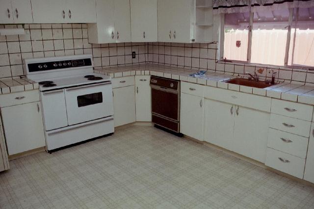 Before any changes - curtains on flat window, old dishwasher