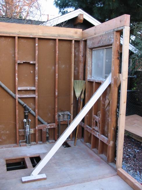 two remaining walls of old bathroom, with no roof