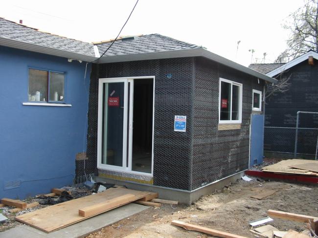 back of house showing black paper and wire