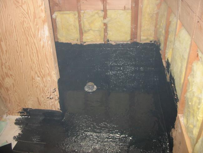 black tarry stuff on floor on bathroom