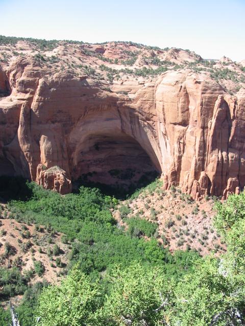 Cave in a cliff and tiny tiny houses in the shadow