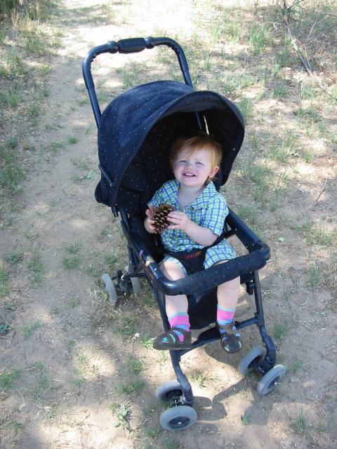 Cielo squints up from her stroller