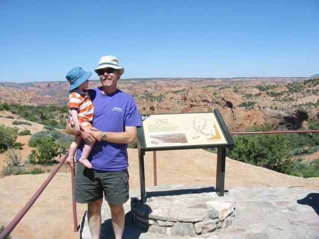 Cielo and Vernon in front of an interpretive panel